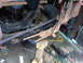 1973 Ford Ranchero - A heavily rusted vehicle frame and suspension parts are shown in a workshop setting.