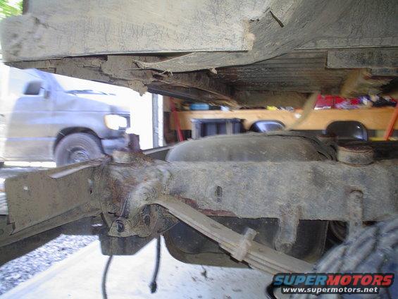 Undercarriage view of a van, with another vehicle partially visible in the background