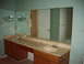 1983 Ford 427 - Interior view of a bathroom a double vanity with marble countertops and wooden cabinets.
