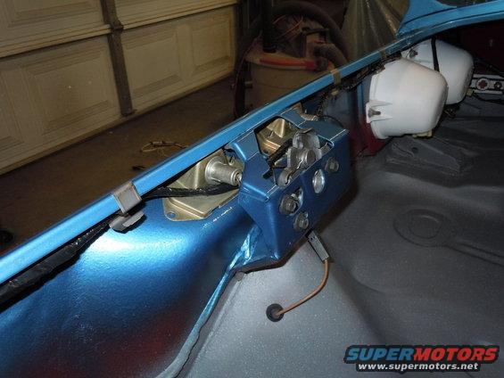 Blue car interior part with wiring and two white components