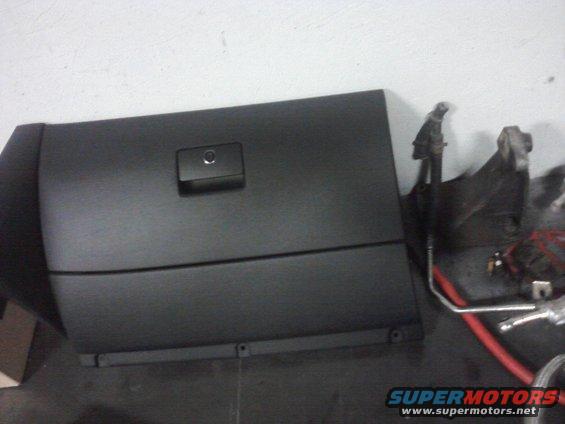 Black glove box door with latch