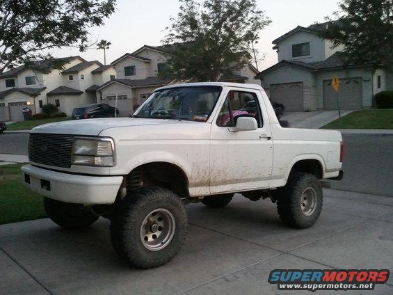 White lifted Ford Bronco parked on a driveway