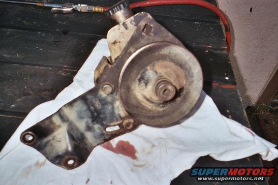 Ford power steering pump bracket with pulley and reservoir, stained and used