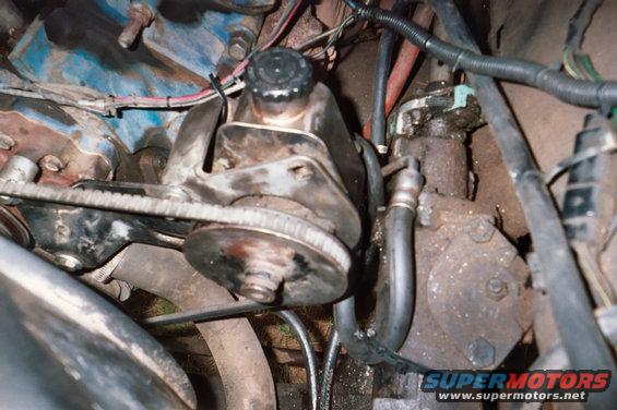 Power steering pump and pulley assembly in an engine bay