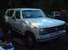1978 Ford Bronco - A white 1978 Ford Bronco is parked outside, with another vehicle visible in the background.