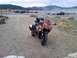 2006 Honda CBR-RR - Sport motorcycle parked on gravel with a lake and mountains in the background.
