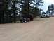 2006 Honda CBR-RR - A dirt parking area with two motorcycles and two SUVs visible among trees and rocks.