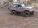 1986 Ford Bronco - This Ford Bronco is navigating a challenging muddy off-road course.