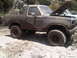 1986 Ford Bronco - This off-road vehicle is covered in mud, suggesting it has been used for off-roading.