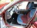 2000 Ford Crown Victoria - The interior of a maroon Ford Crown Victoria shows two-tone cloth seats and a gray dashboard.