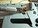2002 Toyota 4Runner - A utility knife is used to modify a metal bracket during a car stereo installation.