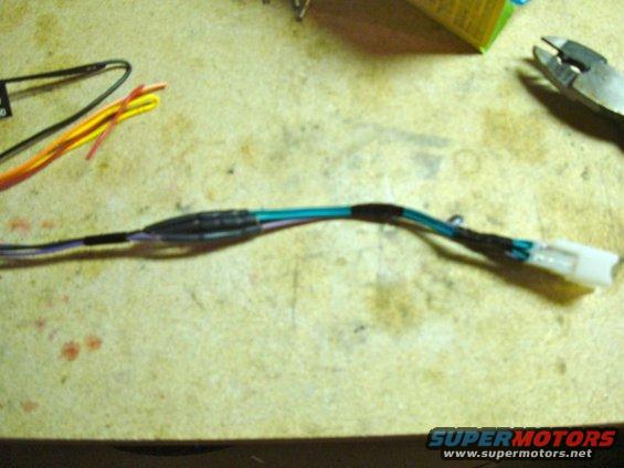 Wiring harness with a white connector and heat-shrink tubing