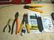 2002 Toyota 4Runner - Tools for electrical work, including wire strippers, crimpers, and heat shrink connectors, are laid out on a surface.