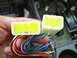 2002 Toyota 4Runner - Close-up of car stereo wiring harness connectors and wires being held.