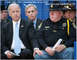 1970 Mercury Cougar - A politician is seated next to police officers, with one officer placing a hand on the politician's shoulder.