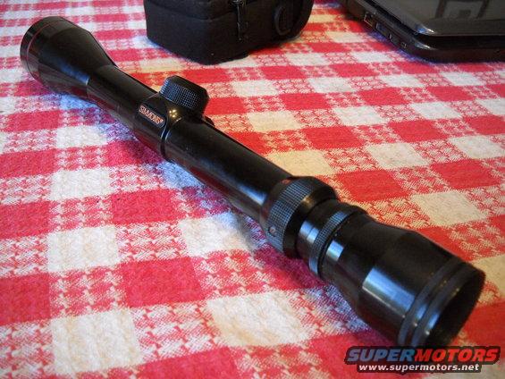 Simmons rifle scope on a red and white checkered tablecloth
