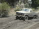 1986 Ford Bronco - This 1980s Ford Bronco navigates a muddy off-road trail.