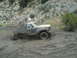 1986 Ford Bronco - This 1980s Ford Bronco is deep in the mud, struggling to get through the mire.