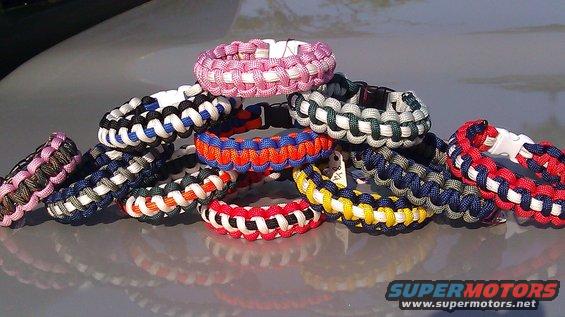 Pile of paracord bracelets in various colors on a car hood
