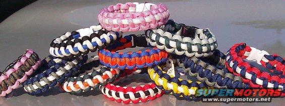 Pile of colorful paracord bracelets on a shiny surface