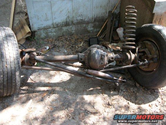 Front axle assembly with coil spring and tire