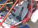 1981 Honda 250 R - Interior view of a buggy with a PYROTECT harness and red roll cage, parked outdoors.