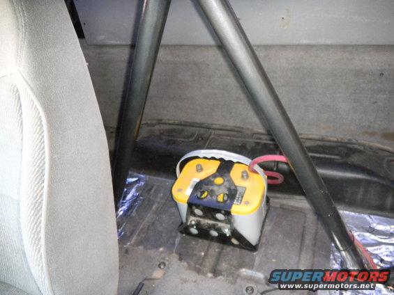 Yellow Optima battery mounted in a vehicle interior with roll cage