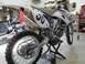 2007 Yamaha YZ450F - A 2007 Yamaha YZ450F dirt bike is shown in a garage setting, with another motorcycle visible in the background.