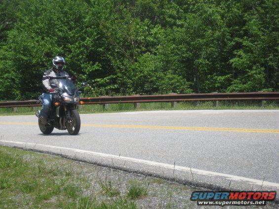 Motorcycle on a road with trees in the background