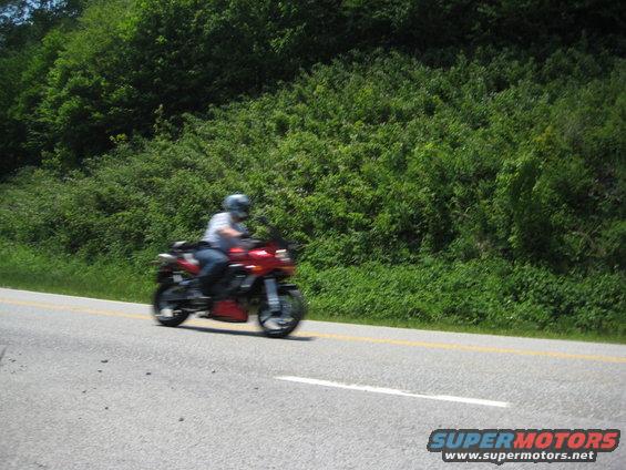 Red motorcycle with rider on a road