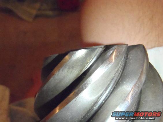 Close-up of worn gear teeth with Supermotors logo at bottom right