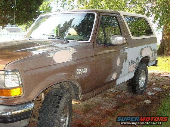 Brown 1993 Ford Bronco with body filler on doors and fenders, 3q-front view