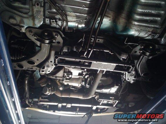 Underside view of car transmission and exhaust system