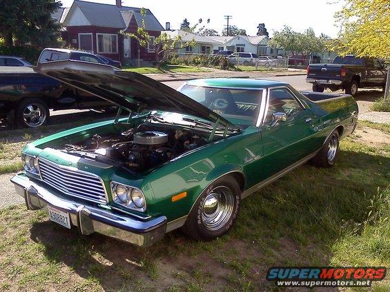Green 1973 Ford Ranchero with hood open, showing engine
