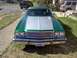 1973 Ford Ranchero - Front view of a green 1973 Ford Ranchero, a silver hood stripe and a prominent chrome grille.
