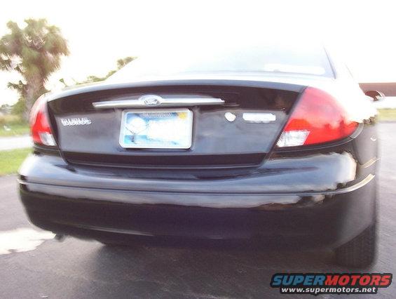 Rear view of a black 2003 Ford Taurus with a license plate