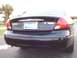 2003 Ford Taurus - The rear of a black sedan is shown, with a license plate and taillights visible.