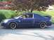 1971 Ford Ranchero - A blue coupe with custom wheels and a spoiler is parked on the side of the road.