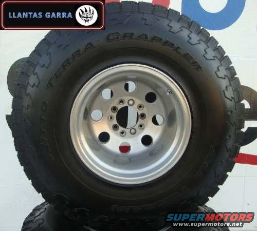 Tire with "TERRA GRAPPLER" text and a silver 5-lug wheel