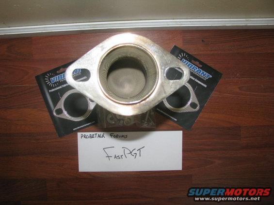 Exhaust flange with two Vibrant Performance gaskets on a wooden floor