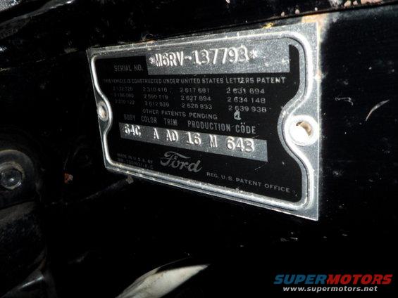 Close-up of a black Ford VIN plate with serial number M6RV-137793