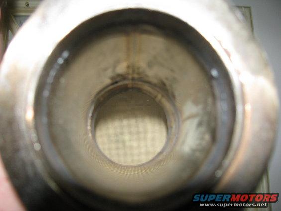 Interior view of a catalytic converter with honeycomb structure visible