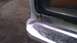 1984 Ford Bronco - The front corner of a vehicle shows a dented bumper and rust near the headlight assembly.