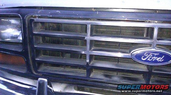 Close-up of a 1980s Ford Bronco grille with a blue Ford oval badge