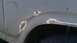 1984 Ford Bronco - This vehicle's fender shows significant rust and damage, requiring repair.