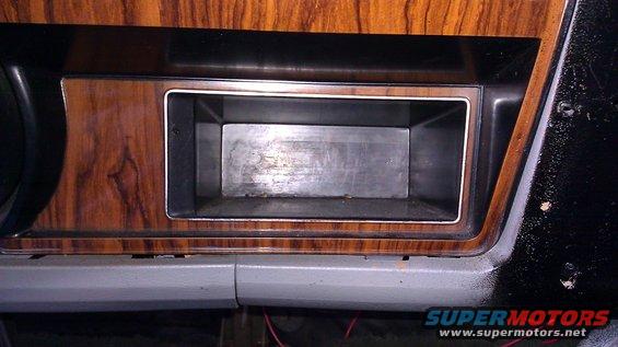 Dashboard compartment with wood grain trim and metal interior