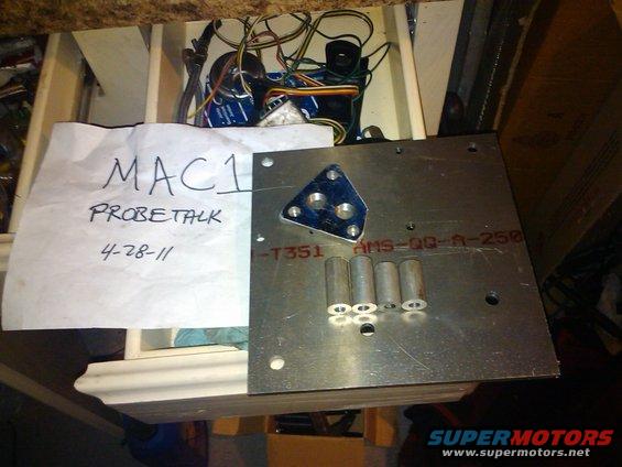Metal plate with electronic components, four cylindrical parts, and a handwritten note reading 'MAC1 PROBETALK 4-28-11'
