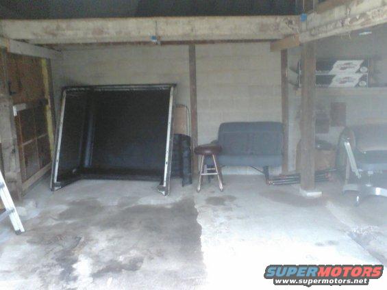 Truck cap in garage with a stool and bench