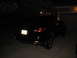 2009 Nissan Murano - Rear view of a black SUV, possibly a 2009 Nissan Murano, parked in a driveway at night.