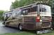 2003 Ford F-350 - This RV motorhome is parked on a paved surface with grass and trees in the background.